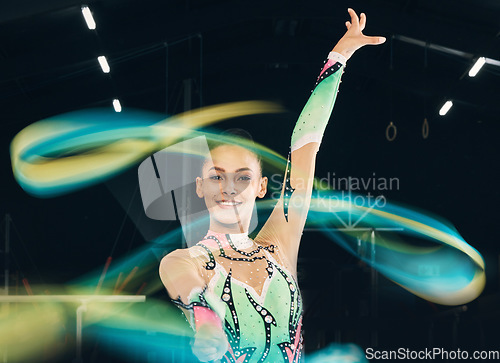 Image of Ribbon gymnastics, happy woman and portrait of motion, dancing performance and competition in dark arena. Female dancer, rhythmic movement and solo routine of creative talent, sports concert or smile