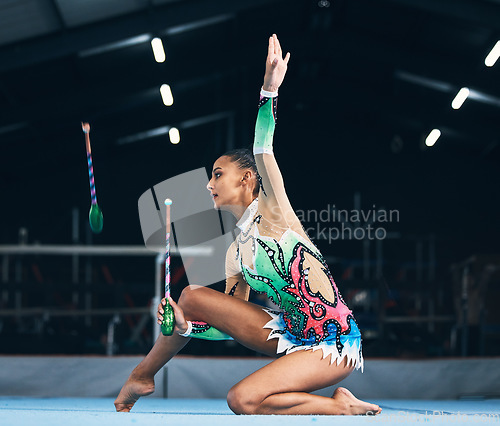 Image of Woman, gymnast and dance stick toss with focus in a gym for dancing performance art. Exercise, training workout and sports competition of an athlete with moving for show for fitness and dancer sport