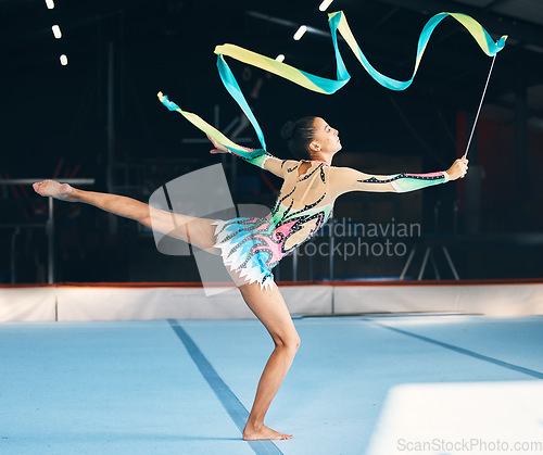 Image of Ribbon, gymnastics and flexible woman stretching in performance, dancer training and sports competition. Female athlete, rhythmic movement and balance for creative skill, talent and concert in arena