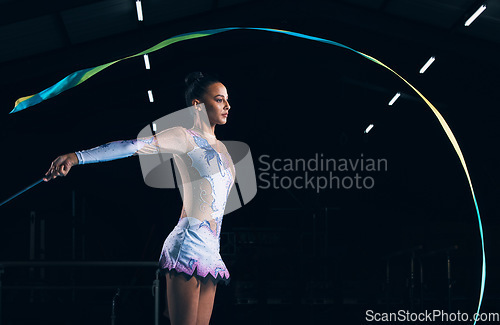 Image of Ribbon gymnastics, woman and serious dancer in talent show, competition and dark mockup arena. Focused female athlete, rhythmic movement and dancing solo performance, creative sports or concert event