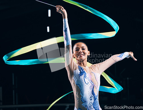 Image of Ribbon gymnastics, happy woman and portrait of dancer in performance, training show and competition in dark arena. Female, rhythmic movement and smile for action, creative talent and sports concert