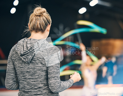 Image of Coaching, gymnastics and cheering with woman in stadium for training, fitness and teaching. Celebration, sports and workout practice with coach and acrobat for performance, flexibility and show
