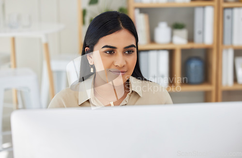 Image of Business, reading or Indian woman typing on computer working on email or research project online. Technology, office feedback or girl journalist writing blog reports or internet articles with focus