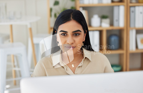 Image of Business, email or Indian woman typing on computer working on search engine or online project research. Technology, office or girl journalist writing blog reports or internet articles with focus.