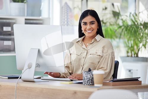 Image of Portrait, happy or Indian woman at a desk typing an email, planning schedule or company goals. Administration, smile or computer of proud Human Resources manager, corporate person or worker in office