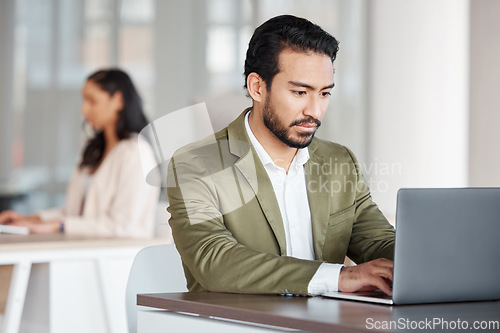 Image of Focused business man typing on laptop at office desk, planning information and digital tech project. Male employee working on computer for data update, website strategy and research for online report