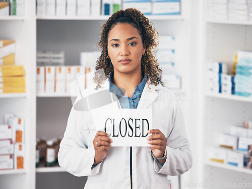 Image of Portrait, woman and closed sign of store, pharmacy and shop in recession, bankruptcy and economy. Serious female pharmacist advertising retail closing with poster, board and announcement in drugstore