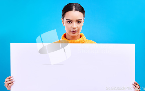 Image of Studio, blank sign and portrait of woman with info and mockup isolated on blue background. Marketing, advertising and gen z girl with poster for product placement or news announcement mock up space.