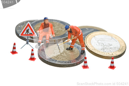 Image of Miniature figures working on a heap of Euro coins.