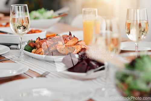 Image of Food, party and celebration with table in dining room for event, thanksgiving and gathering. Nutrition, diet and cuisine with meal and wine at home for sharing, community and Christmas dinner