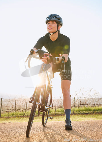 Image of Rest, cycling and fitness with woman in nature for training, workout and sports cardio. Health, relax and thinking with female cyclist riding on bike in outdoor for exercise, endurance and challenge