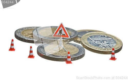 Image of Miniature figures working on a heap of Euro coins.