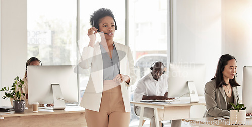 Image of Call center, manager and black woman in office, sales company and coworking customer service agency. Female telemarketing agent talking on headset for consulting, crm advisory and telecom questions
