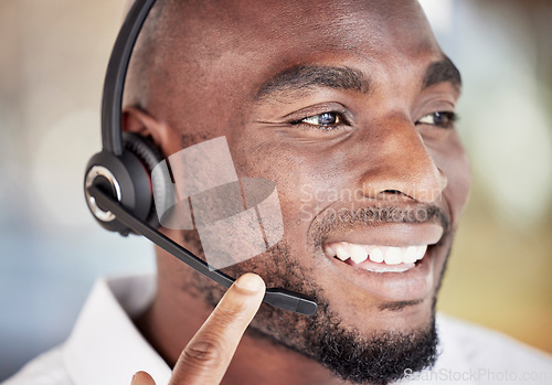 Image of Call center, black man and face talking in office, customer service and sales consulting. Telemarketing, happy male consultant and telecom agent for faq questions, business advisory and crm support