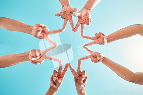 Image of Hands, star and group of people in teamwork, collaboration and support outdoors in a circle for solidarity together. Fingers, community and team making hand sign or shape in the sunshine