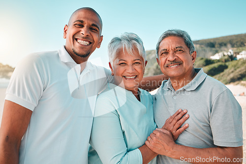 Image of Happy, hug and a portrait of a family at the beach for bonding and quality time on the weekend. Smile, relax and a senior mother and father hugging with an adult man during a holiday at the sea