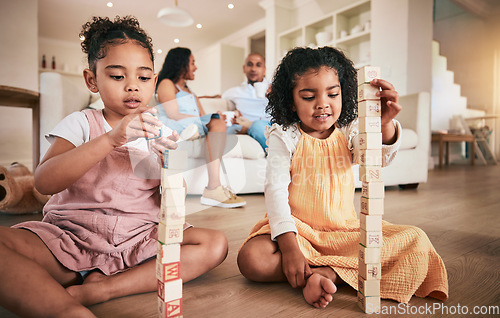 Image of Toys, building blocks and children on a living room floor for bonding, learning and having fun with parents. Family, education and block activity by kids with creative cubes for development at home