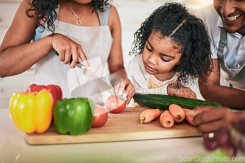 Image of Family, cutting vegetables and cooking together, learning chef skill with parents and child in kitchen. Nutrition, healthy food and organic with people teaching and learn to cook at home with bonding