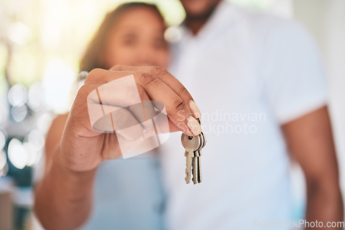 Image of Keys, home and hands of couple in apartment excited for moving into new house, property and real estate. Homeowners, relationship and happy man and woman with key for mortgage, investment and rent