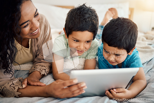 Image of Tablet, education and a mother with her children on a bed at home in the morning together for entertainment. Family, boy or brother with a woman and her kids learning online in the bedroom of a house