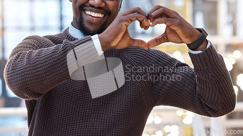 Image of Hands, heart and black man showing love gesture, sign or symbol feeling happy, support excited in an office. Care, employee and businessman with loving or hearty shape, emoji and icon at work