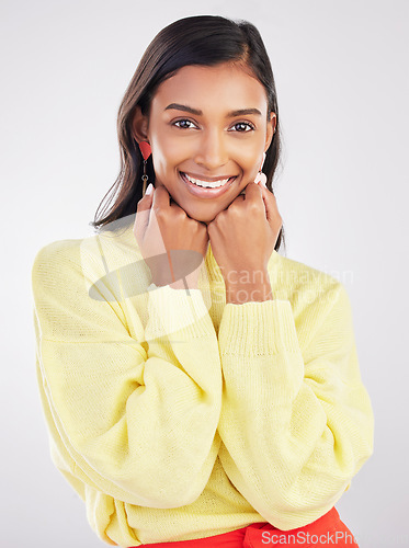 Image of Happy, smile and portrait of a woman in a studio with a casual outfit and positive mindset. Happiness, excited and face of a stylish Indian female model with fashion isolated by a gray background.