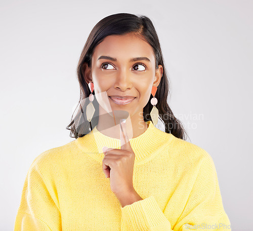 Image of Face, idea and smile with a woman on a white background in studio closeup to decide on a choice. Head, thinking and happy with an attractive young female contemplating a thought about her options