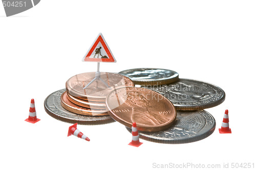 Image of Miniature figures working on a heap of Dollar coins.