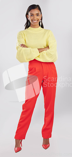 Image of Fashion, happy and portrait of a woman in a studio with a stylish, trendy and casual outfit. Smile, style and full body of an Indian female model with crossed arms for confidence by a gray background