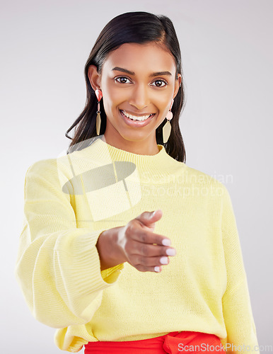 Image of Woman, smile in portrait and handshake, agreement and partnership deal with onboarding and recruitment on studio background. Collaboration, happy female and networking with welcome and thank you