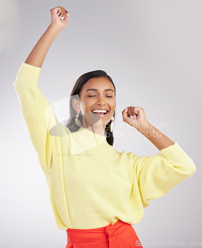 Image of Happy, excited and woman dance, celebration and cheerful against a grey studio background. Female dancer, model and person moving, groove and happiness with routine, motivation and stress relief