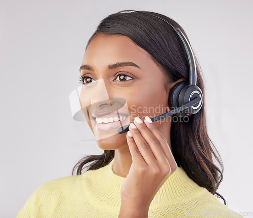 Image of Happy woman has smile on face, callcenter and headset with mic, CRM and contact us with consultant on studio background. Indian female, customer service agent and help desk with tech support worker
