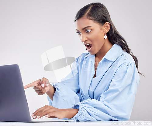 Image of Shock, laptop and a pointing business woman in shock on a white background in studio while working. Wow, computer and hand gesture with a surprised female employee looking at an online notification