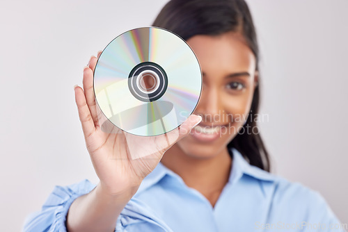 Image of Portrait, happy and woman with cd, excited and technology against a white studio background. Face, female model and person with compact disc, music and sounds with happiness, audio and multimedia