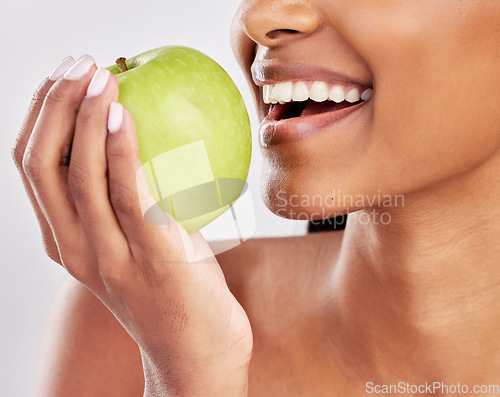 Image of Woman, apple in hand and health with nutrition and fruit closeup, healthy food and diet on studio background. Weight loss, organic and fresh produce with happy female mouth, wellness and lifestyle