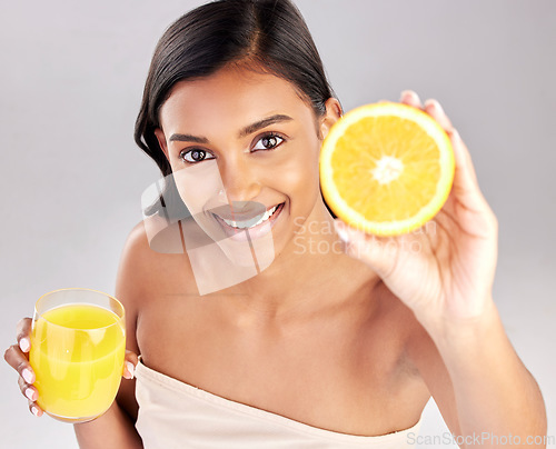 Image of Happy woman, orange juice and fruit in portrait, health and nutrition with healthy drink and diet on studio background. Weight loss, organic and citrus beverage, vitamin c and female with wellness