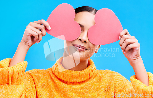 Image of Heart eyes, cover and woman smile with happiness and excited for love, valentines day or studio emoji. Happy, loving or person on isolated blue background, creative romance paper and show care symbol