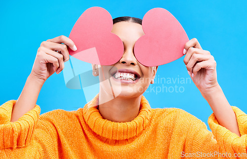 Image of Heart eyes, cover and woman with happiness and excited about love, valentines day or emoji. Happy, smile and person with isolated blue background, loving or creative romance paper symbol to show care