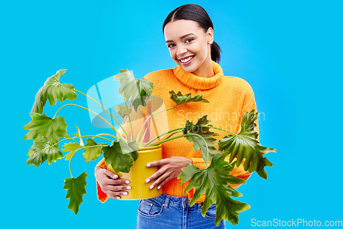 Image of Portrait of happy woman in studio with plant, smile and happiness with house plants on blue background. Gardening, sustainable and green hobby for gen z girl on mockup for eco friendly garden shop.