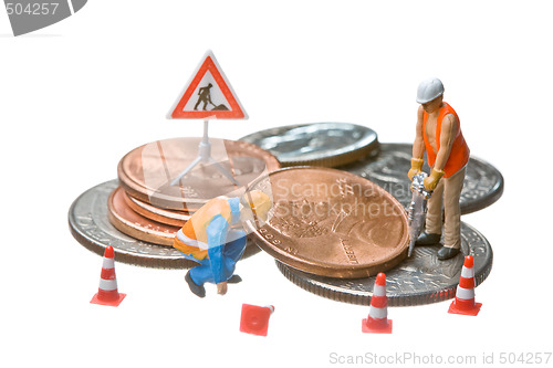 Image of Miniature figures working on a heap of Dollar coins.