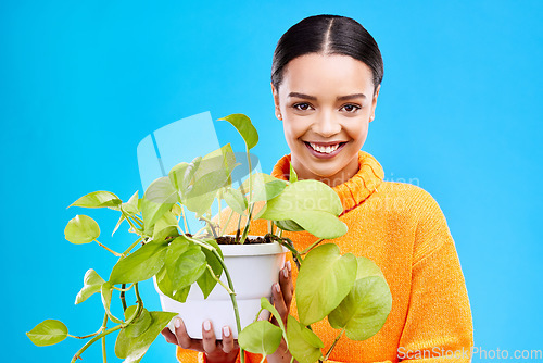 Image of Portrait of woman with green plant, smile and happiness for house plants on blue background. Gardening, sustainable and hobby for happy face, gen z or girl on mock up for eco friendly garden shop.