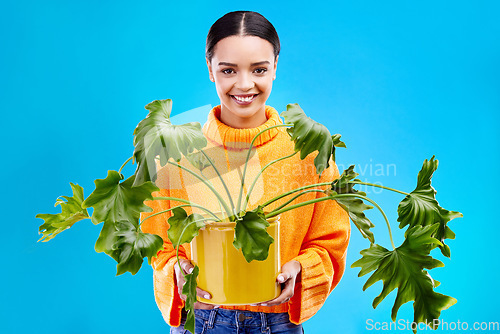 Image of Portrait of happy woman on blue background with plant, smile and happiness with house plants in studio. Gardening, sustainable or green hobby for gen z girl on mockup for eco friendly garden shop.