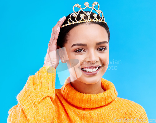 Image of Pride, crown and portrait of woman in studio for celebration, princess and party. Smile, beauty and fashion with female and tiara on blue background excited for achievement, winner and prom event