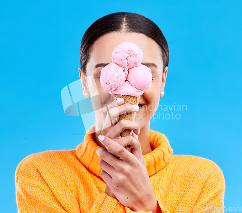 Image of Ice cream, cover and hide with woman in studio for snack, dessert and sweets. Diet, summer and junk food with female and frozen gelato isolated on blue background for sugar, nutrition and mockup