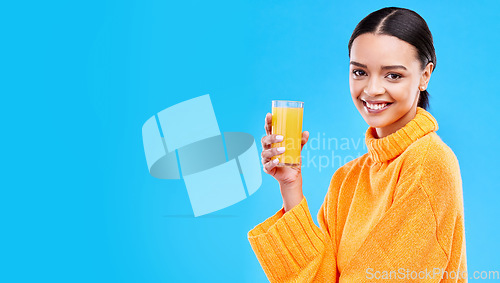 Image of Orange juice, happy and portrait of woman in studio and mockup for nutrition, health and diet. Vitamin c, fruit and fresh with female drinking on blue background for citrus, fiber or organic beverage