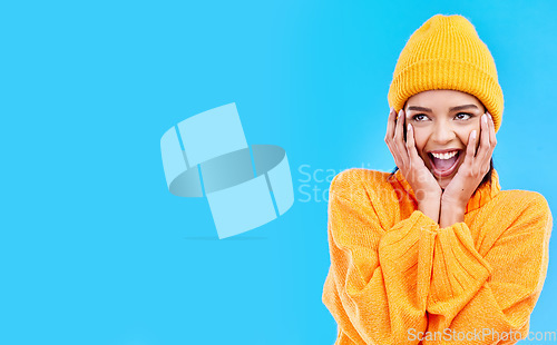 Image of Happiness, surprised and woman hands on studio mockup ready for cold weather with winter fashion. Isolated, blue background and surprise emoji with a happy, young and gen z person with wow and smile