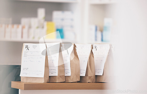 Image of Healthcare, pharmacy and prescription medicine in paper bag, product and pills at counter of drugstore service. Pharmaceutical background, empty retail dispensary and medical supplements in package