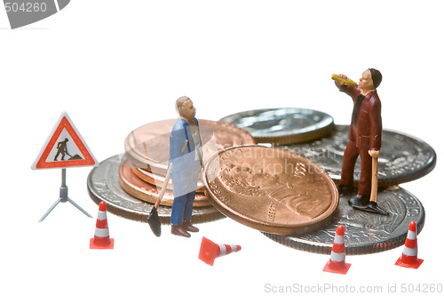 Image of Miniature figures working on a heap of Dollar coins.