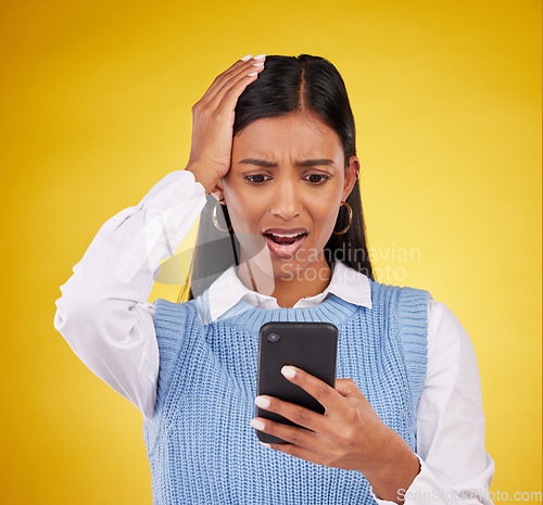 Image of Problem, bad news and a woman with a notification on a phone isolated on a studio background. Sad, glitch and an indian girl reading a message on a mobile app with shock and surprise on a backdrop