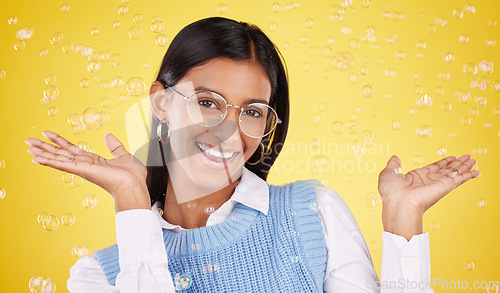 Image of Happy, bubbles and portrait of a woman in a studio with glasses for eye care, optical wellness and health. Happiness, smile and female model with spectacles and positive mindset by yellow background.